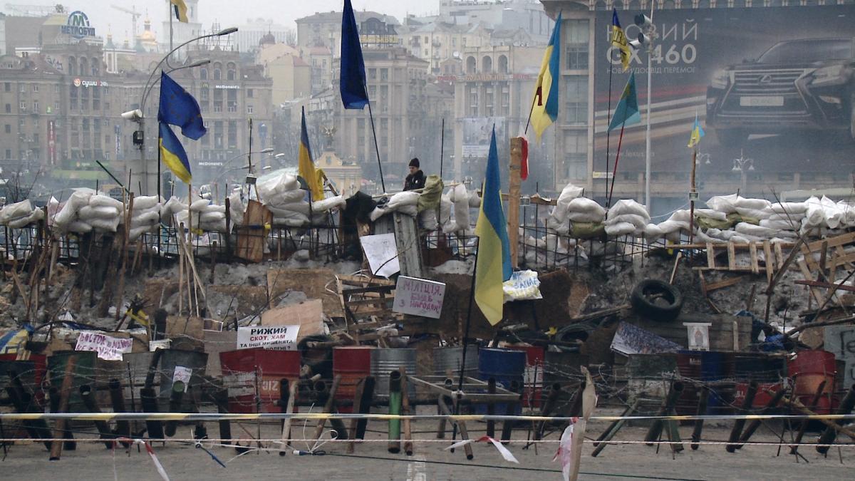 urban landscape with rubble and Ukrainian flags