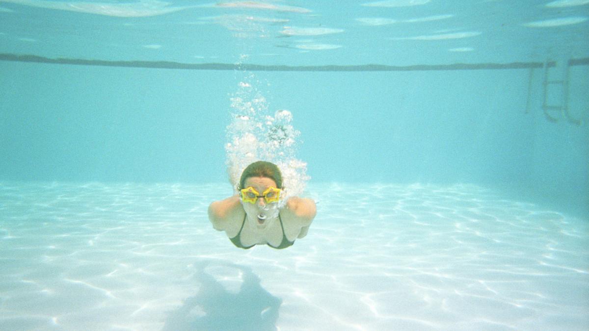 girl swimming in pool underwater
