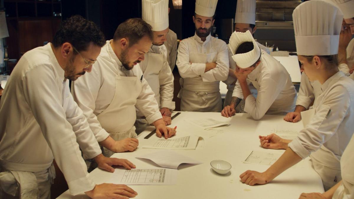 group of chefs standing around table