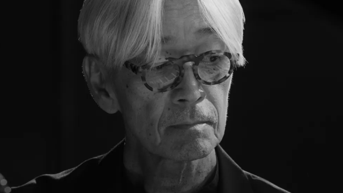 close up of Asian man with gray hair wearing glasses