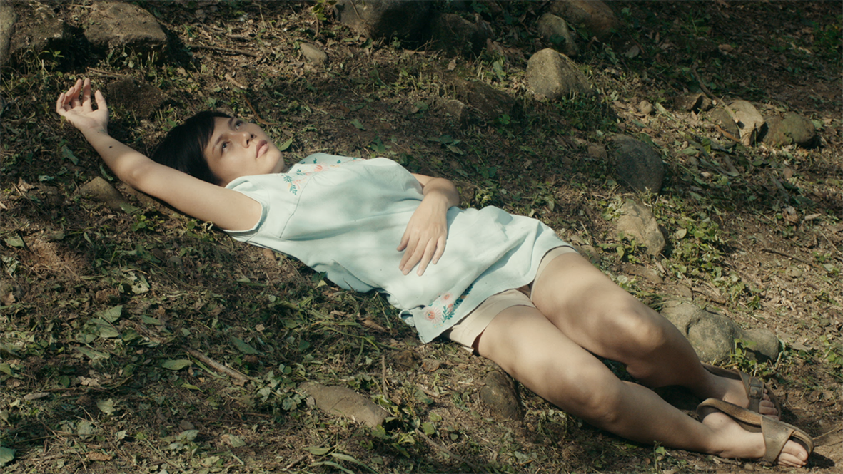 woman lying on forest floor