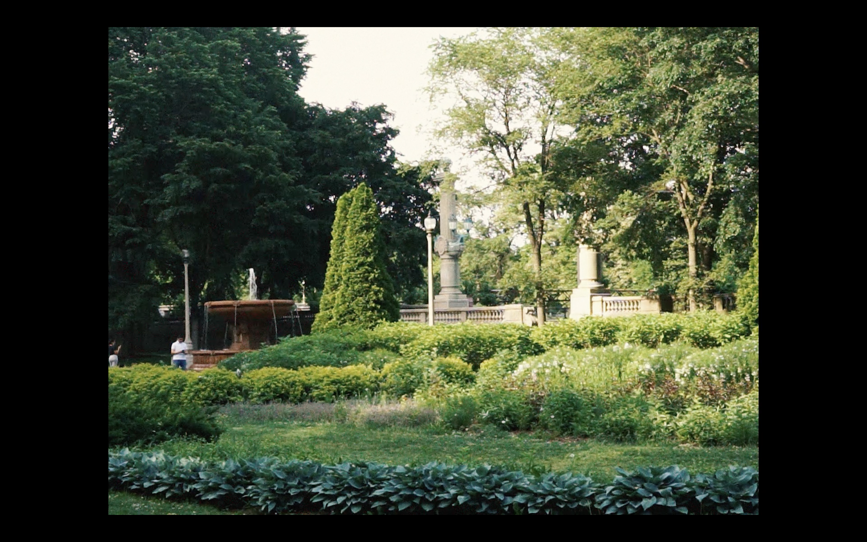 image of a park full of greenery and fountains and pathways
