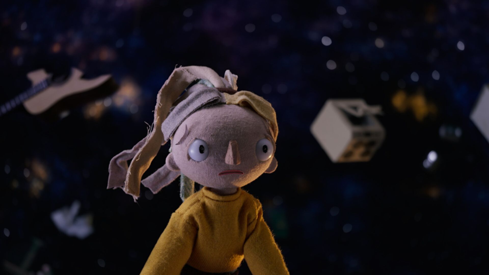 THE TORNADO OUTSIDE, stop motion figure of girl with ponytail wearing yellow jacket with dark background