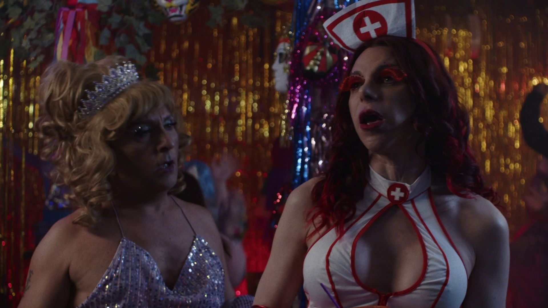 TSIKITIGKLON, THE FAIRY AND THE MAN, two woman in costumes standing on side of wall at party