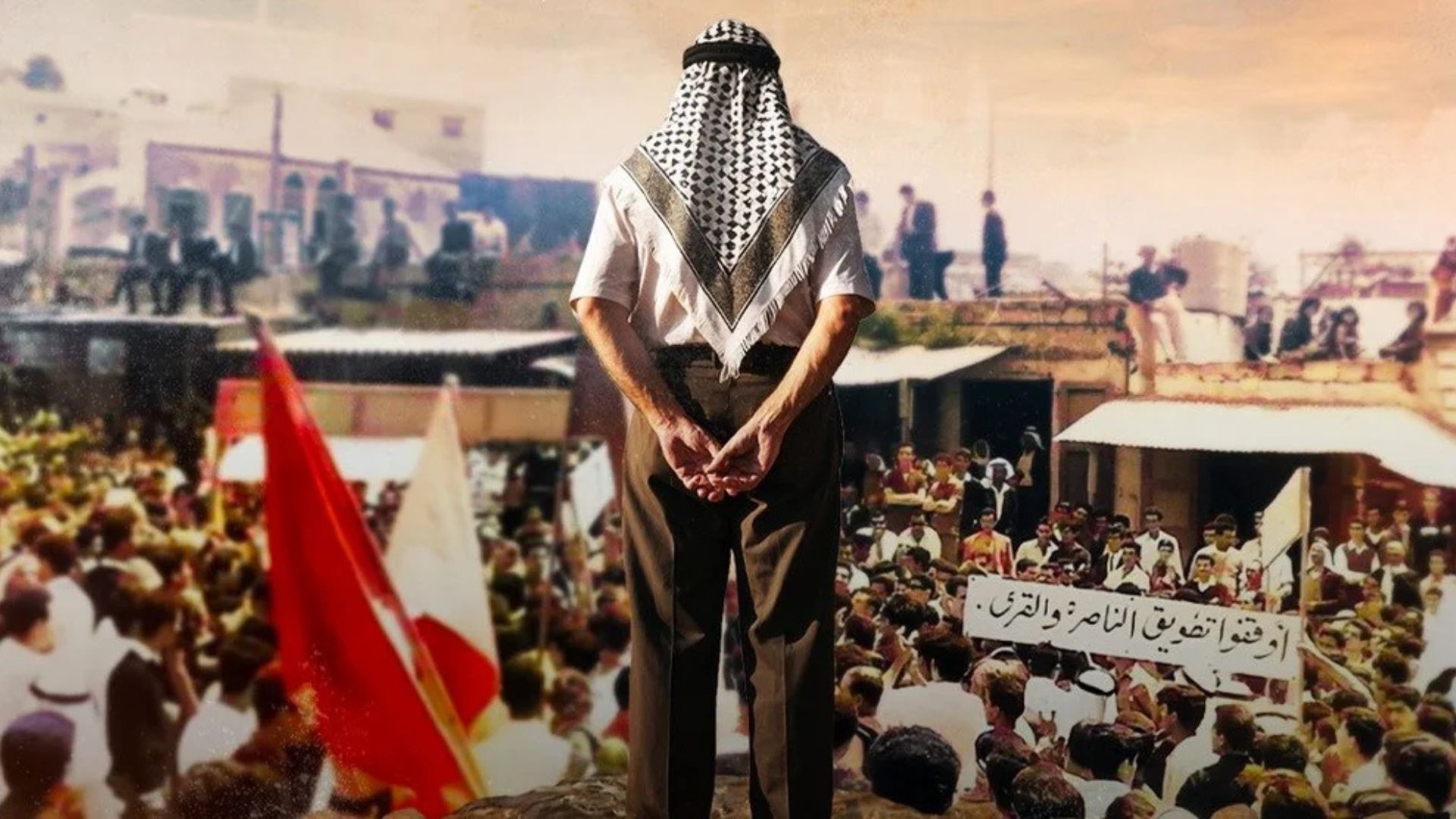 THE UNTOLD INTIFADA 1958, back side of a man standing high above large crowd looking over them with arms folded behind him