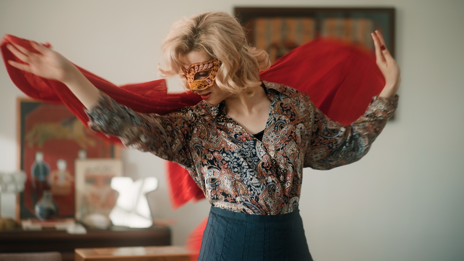 THE FRIEND'S HOUSE IS HERE, 2026, blonde woman in skirt and blouse holding red scarf behind her head