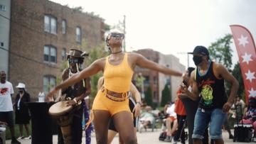 girl in yellow outfit dancing in the street