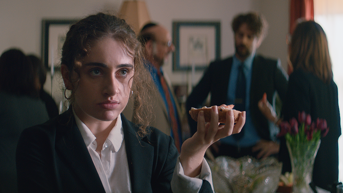 Person holding a bagel, looking upset