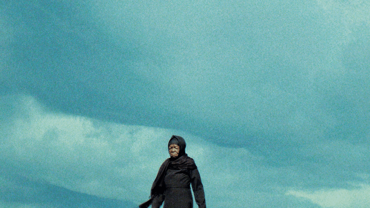 older person wearing all black walking 