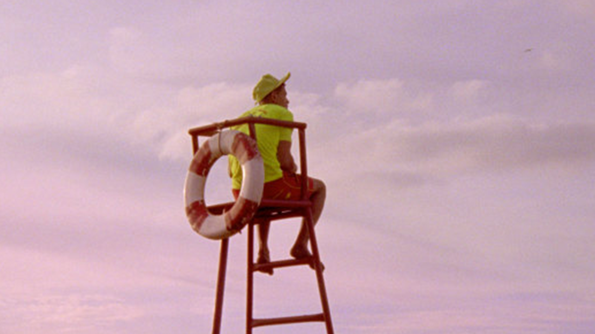 person sitting on a lifegaurd chair