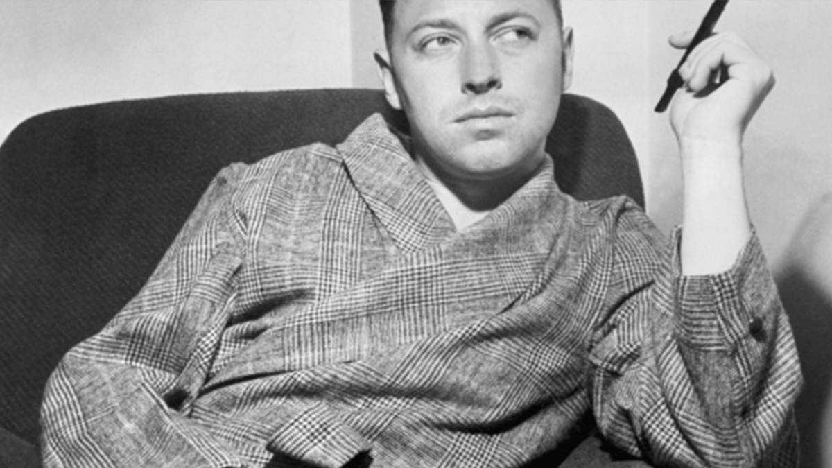 man smoking cigar in a robe