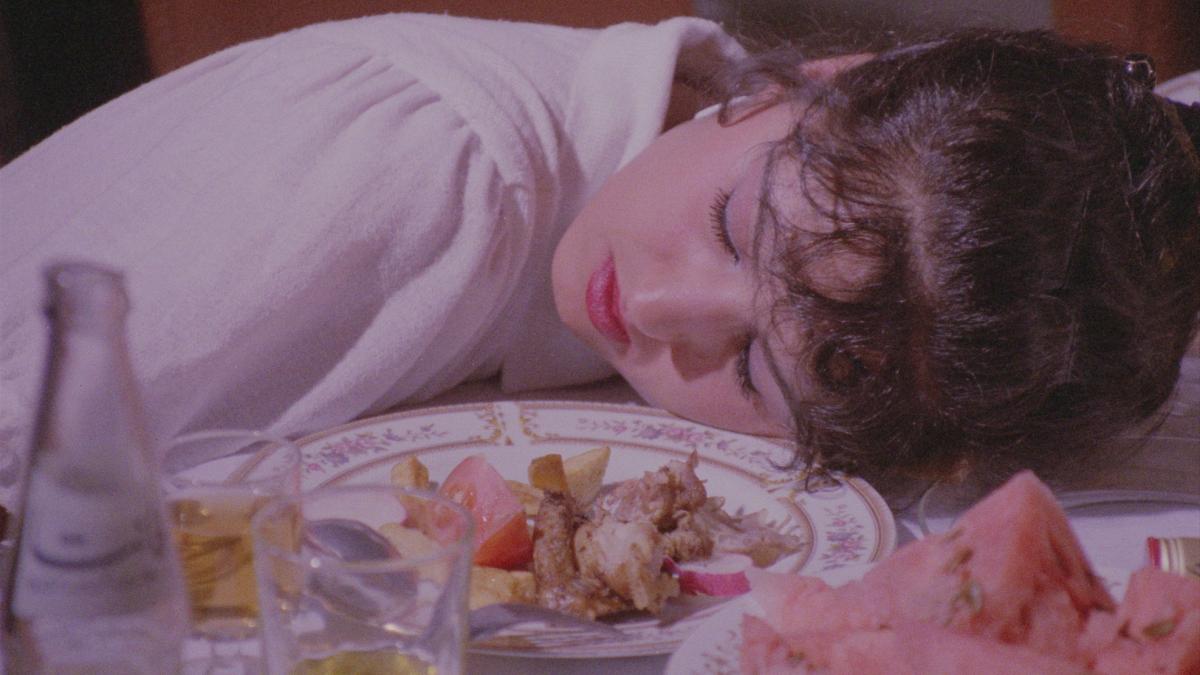 Woman laying on table with plate