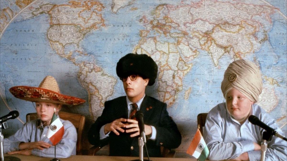 Three men in hats sitting in front of map