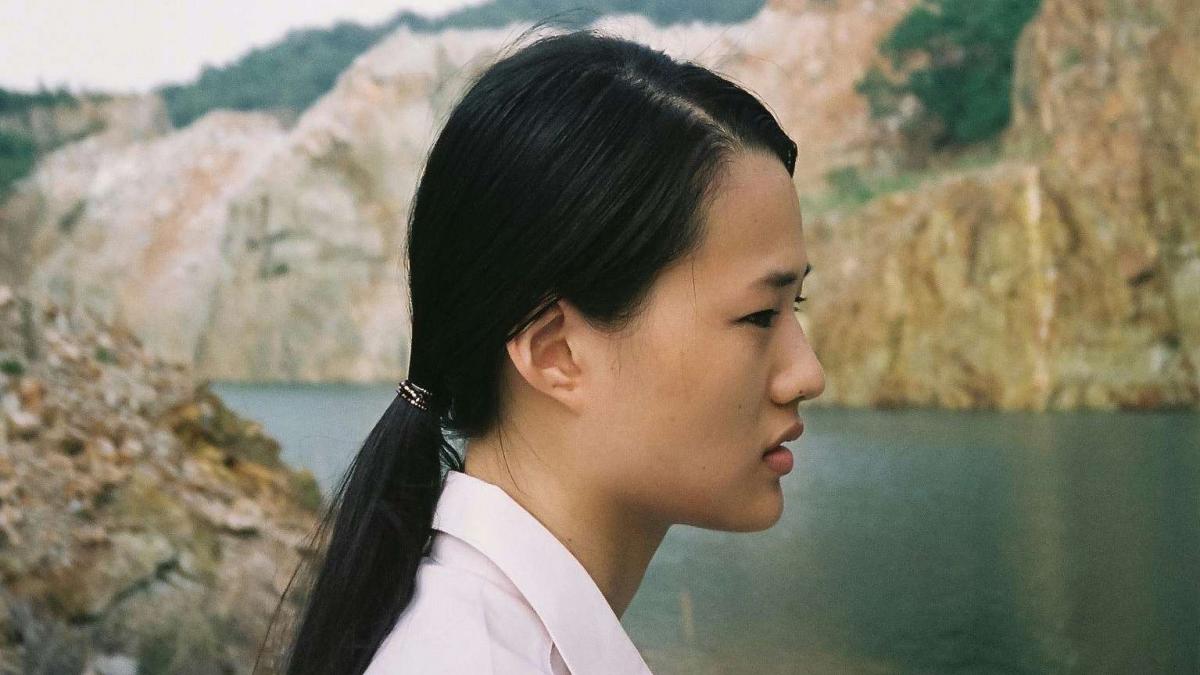 Side profile of woman by water 