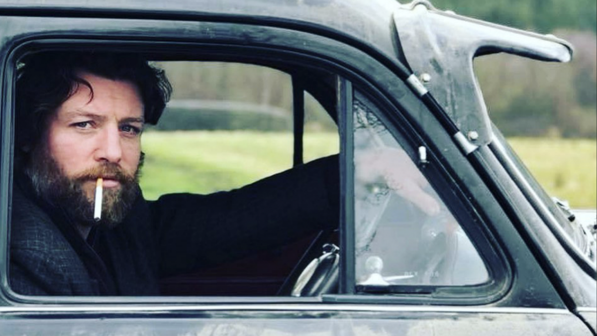 man smoking cigarette in car