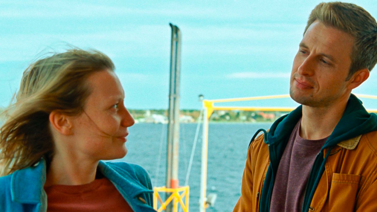 man and woman talking by sea