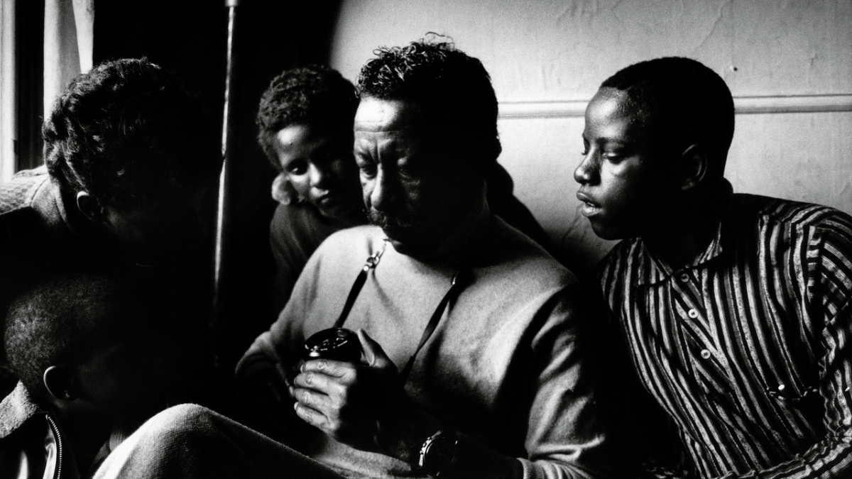 man holding camera sitting with children
