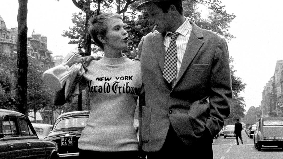 man and woman walking down street