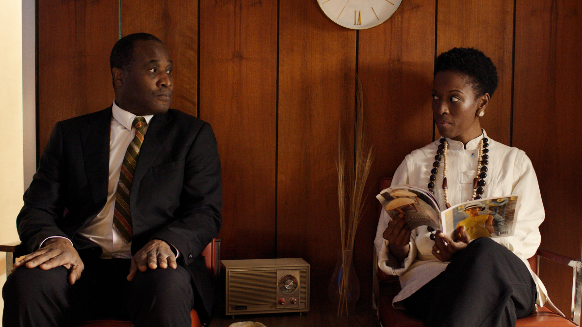 man and woman sitting in waiting room