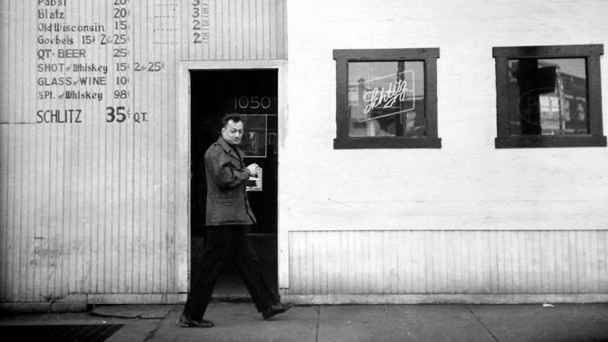 man walking down sidewalk