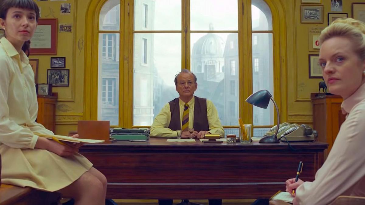 two women turning around at desk