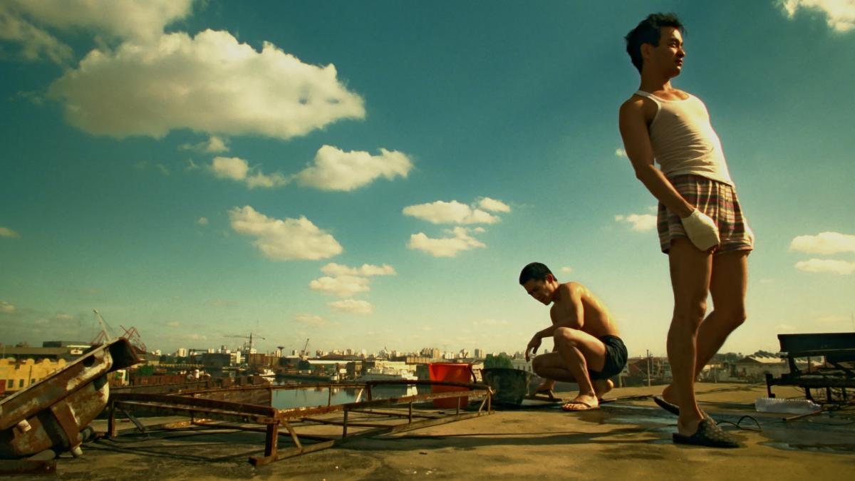 two men standing near water outside