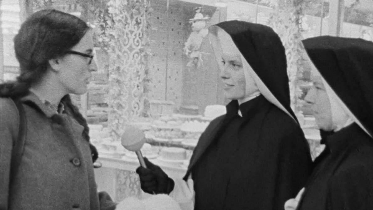 two nuns interviewing woman on the street