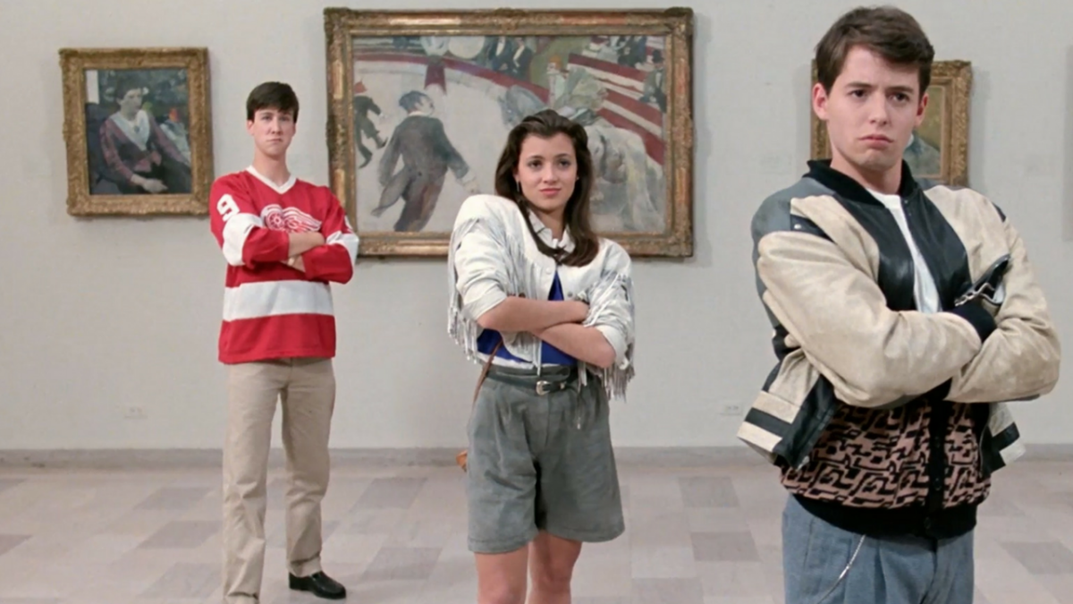 three people standing with arms crossed in art museum 