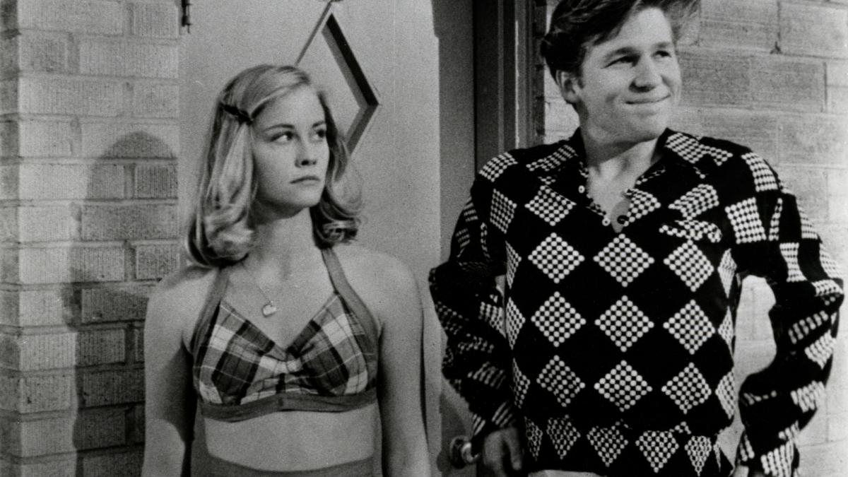 girl looking at boy standing next to her