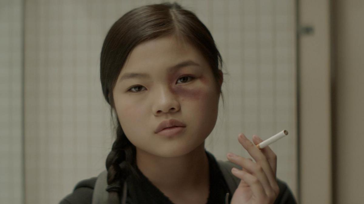 girl with black eye smoking a cigarette 