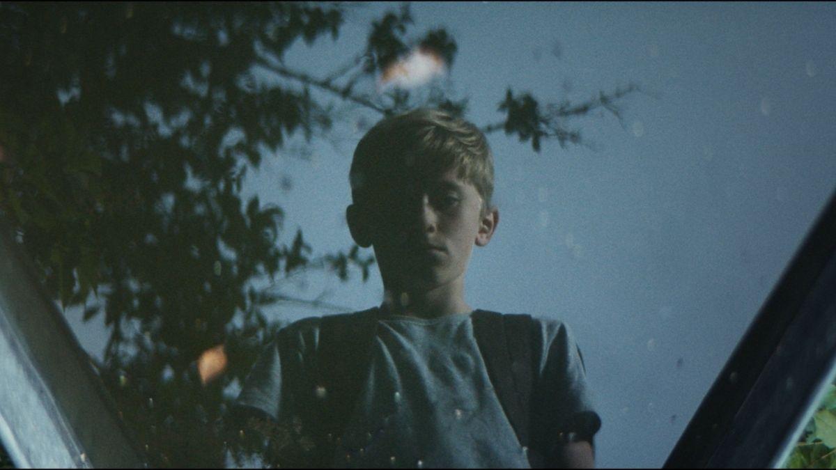 child standing over reflecting glass