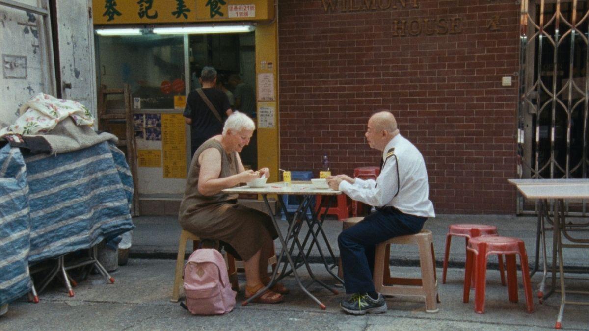 man and woman sitting outside at a table
