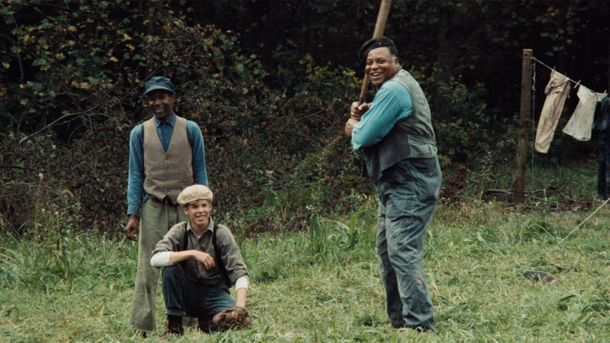 men in yard playing baseball