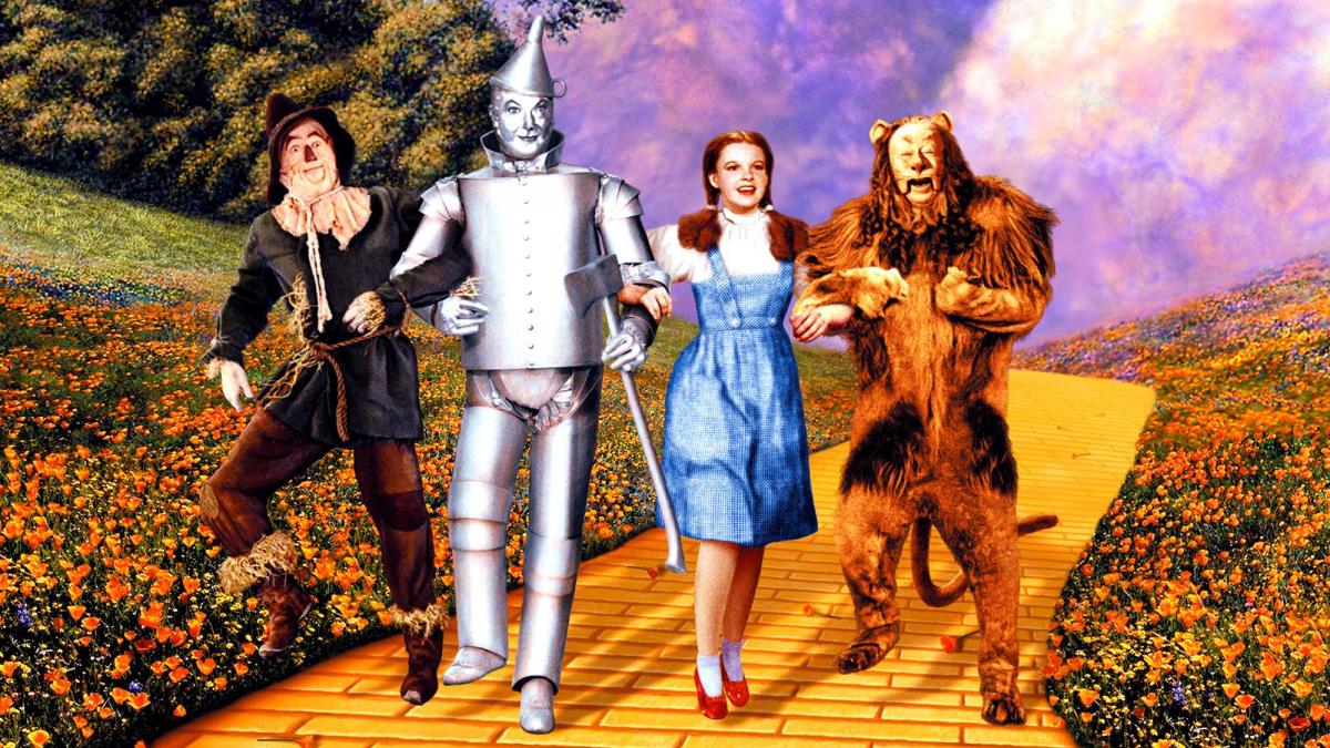 scarecrow, tinman, girl in gingham dress, and lion walking down yellow brick road