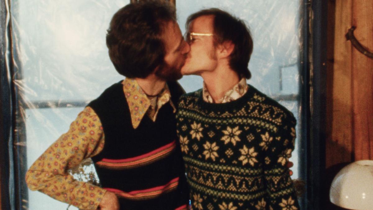 two men in sweaters kissing