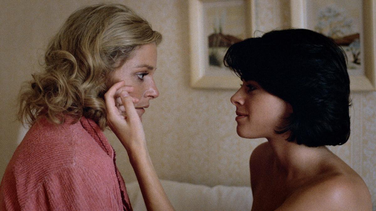 woman touching other woman's face