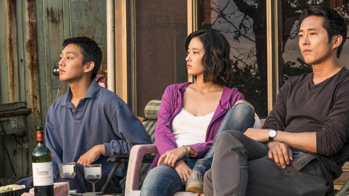 three people sitting outside looking off into distance