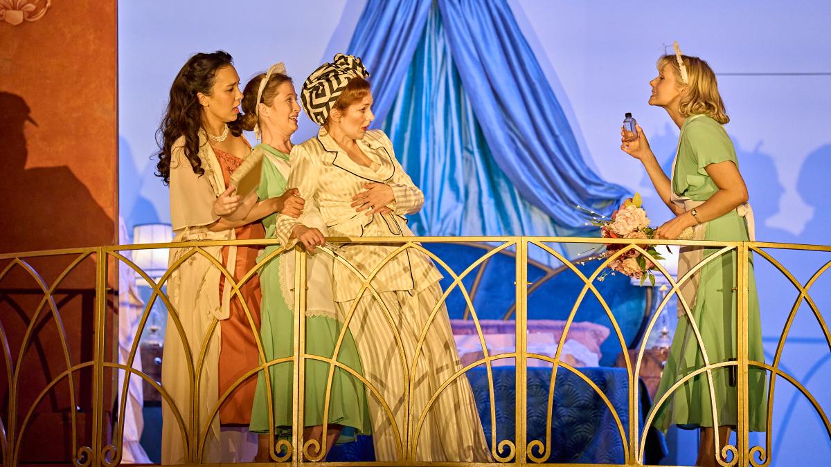 four women on balcony in nightwear