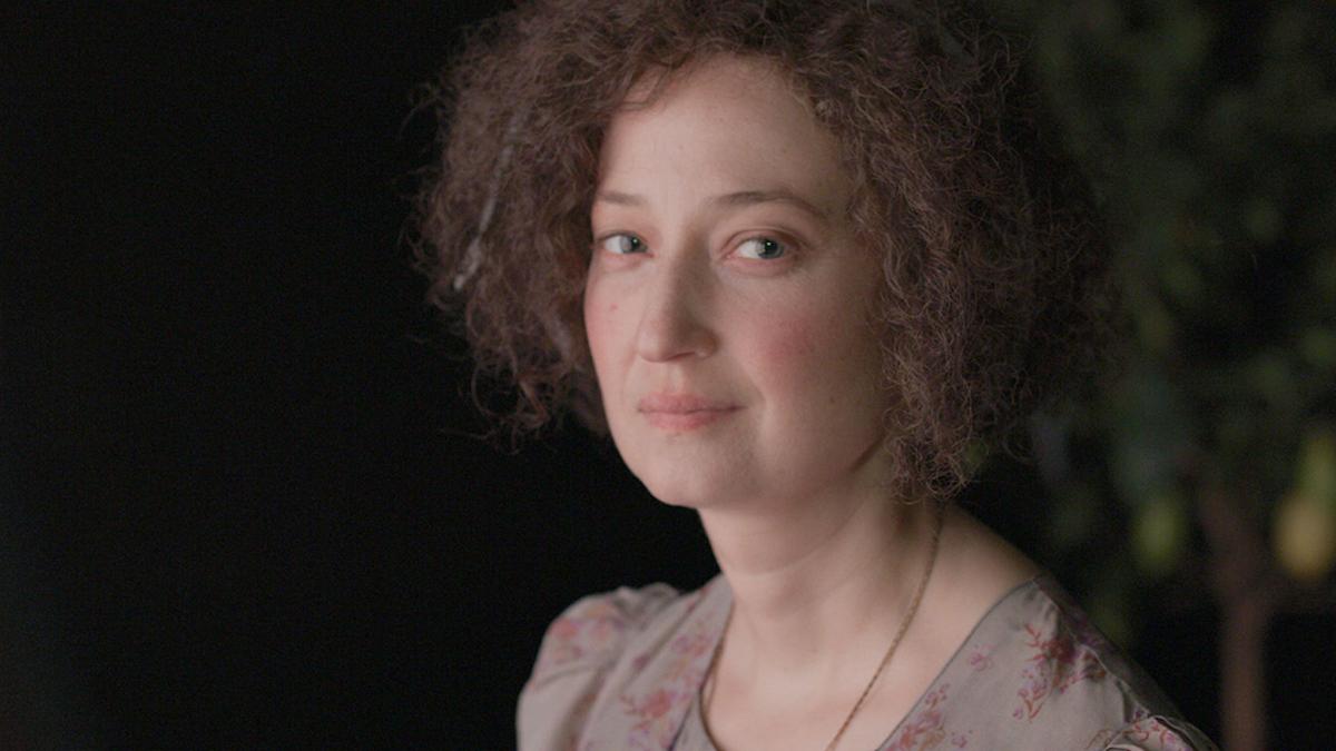 close up of woman turned and looking in camera