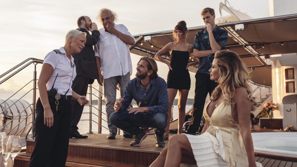 group of people on deck of a boat in semi circle