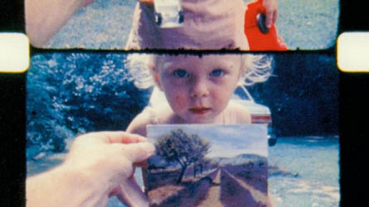 film strips of child in yard looking at camera