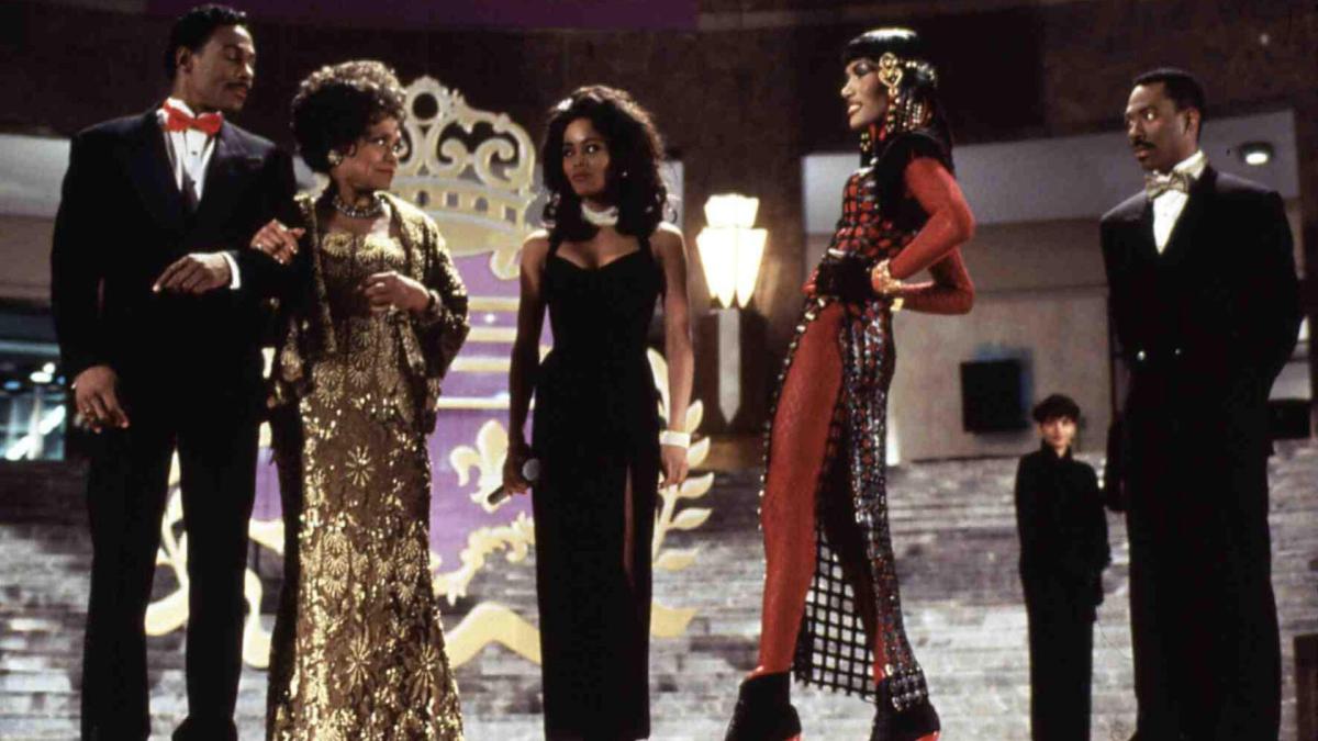 five people on stage in formal wear