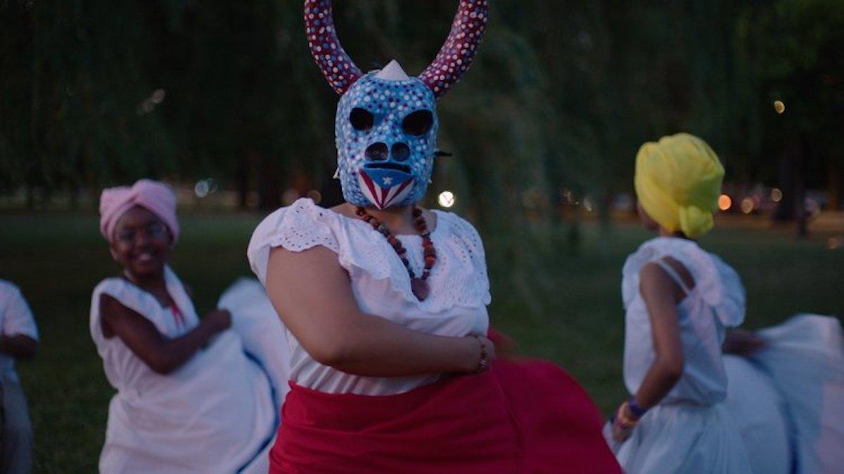 people wearing masks and dancing