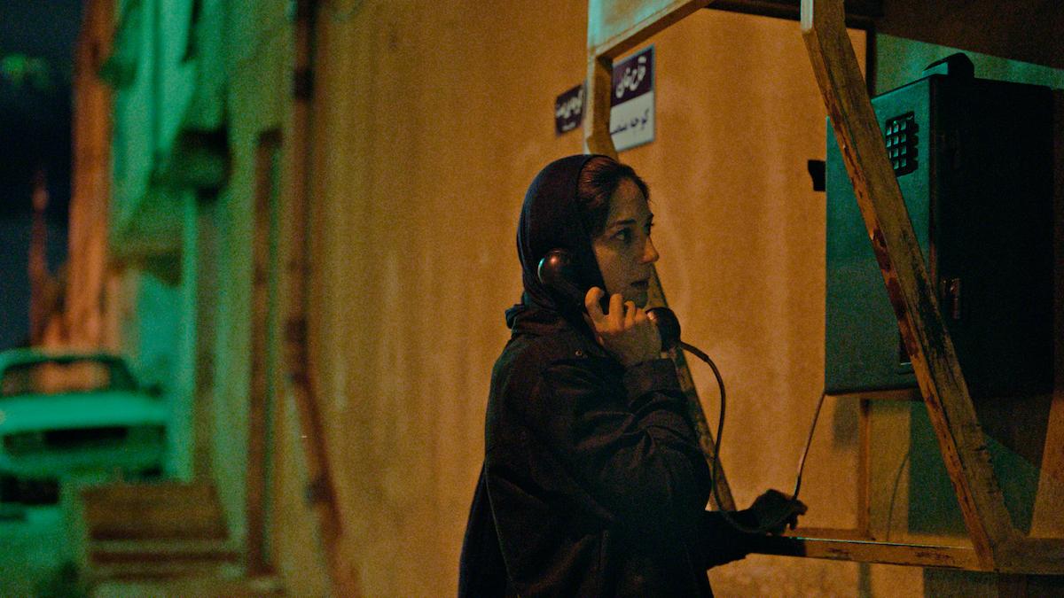 girl in dark alleyway on the phone