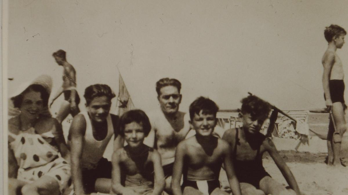 black and white family photo taken at the beach