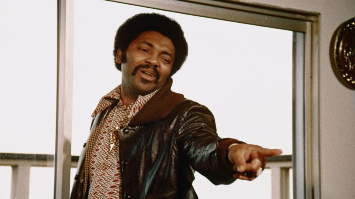 man in leather jacket pointing finger