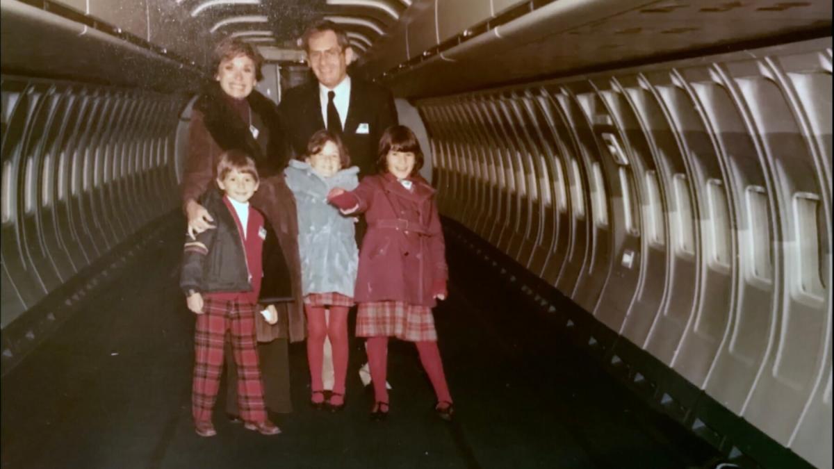 family of 5 standing and posing in long tunnel