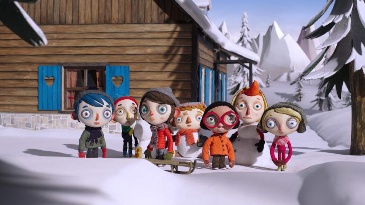 stop motion animation of group of children wearing winter gear in snow in front of cabin