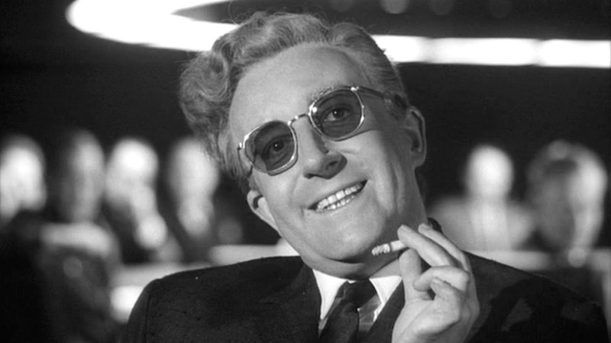 man wearing sunglasses and suit holding a cigarette