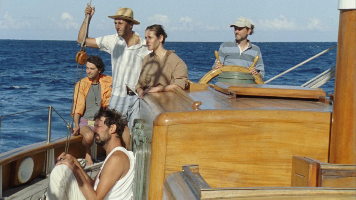group of people standing on boat in casual clothing